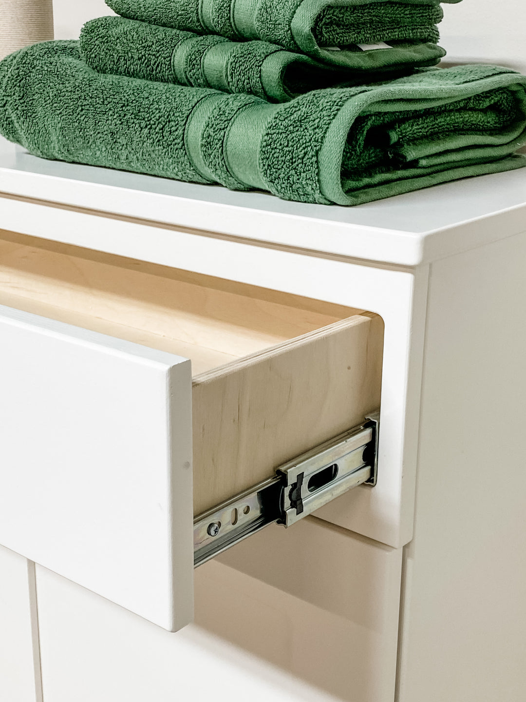 Triple counter tall laundry with a storage drawer in white