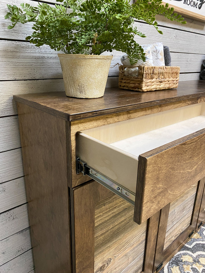 Counter tall quad trash cabinet with a storage drawer in warm brown stain