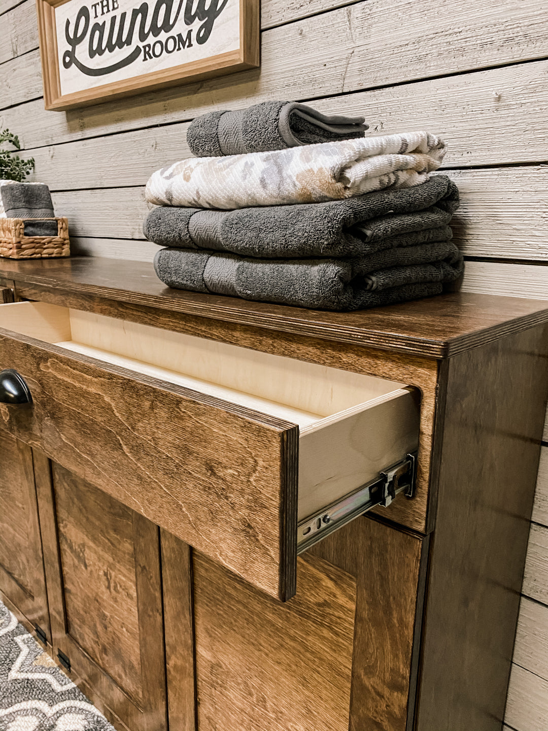 Quad laundry with a storage drawer in warm brown stain