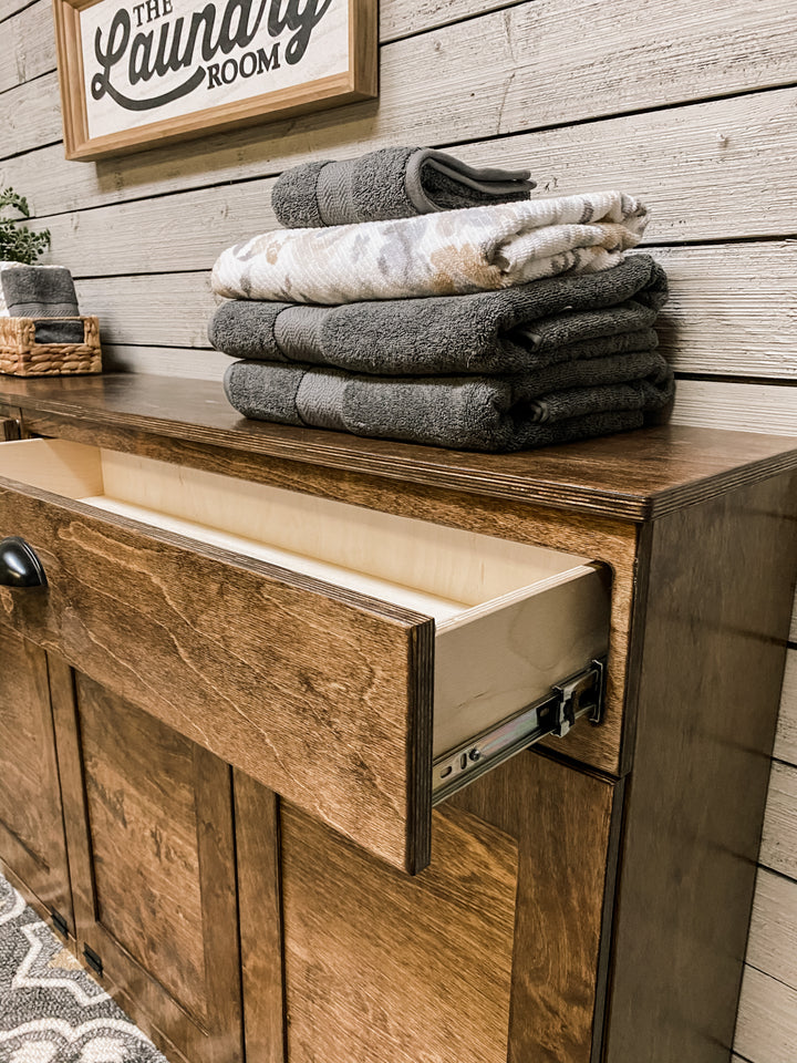 Quad laundry with a storage drawer in warm brown stain