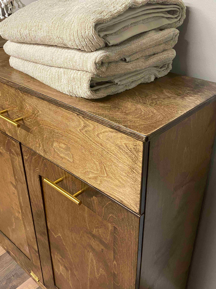 Counter tall quad trash cabinet with a storage drawer in warm brown stain