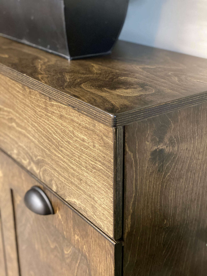 Laundry sorter with four bins and a storage drawer in dark brown stain