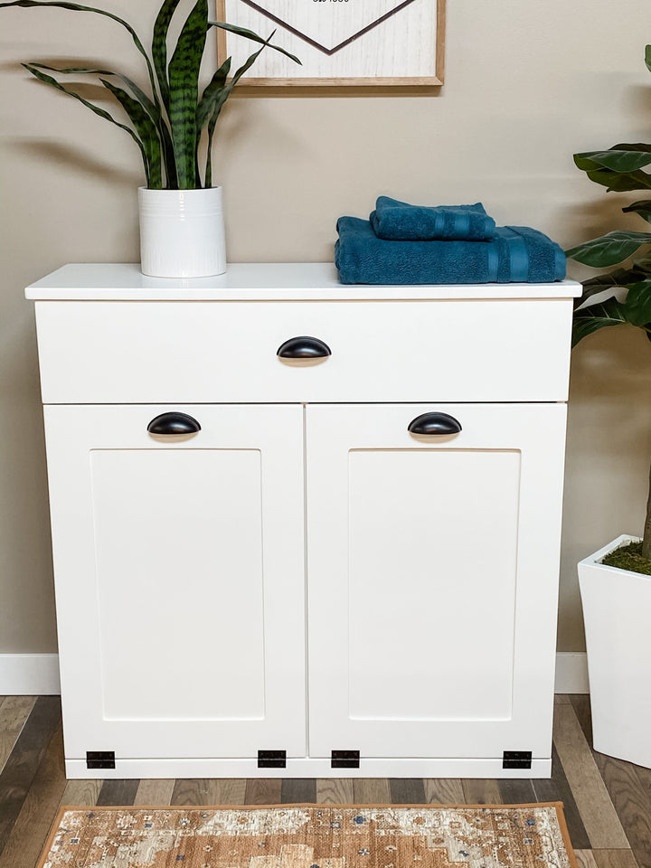 White furniture style laundry double hamper with a storage drawer