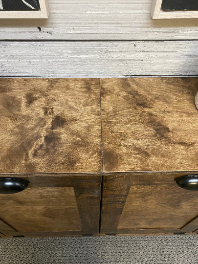 Laundry sorter with four bins and a storage drawer in dark brown stain